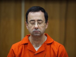 FILE - Larry Nassar listens during his sentencing at Eaton County Circuit Court in Charlotte, Mich., Feb. 5, 2018.