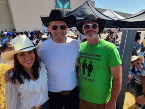 Federal Conservative Leader Pierre Poilievre and his wife, Anaida, pose for a photo with an unidentified man wearing a "straight pride" T-shirt during a Calgary Stampede event in Calgary, Alta., in a recent photo published to Twitter by user @BSpence1983.