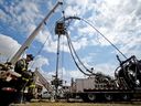 FILE: A worker takes a break outside of a fracking operation at a site near Rosebud.