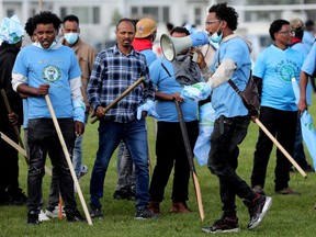A riot between anti-Eritrean government protesters (pictured in blue) and pro government Eritrean supporters broke out during at the Rosslyn Park soccer fields, 113A Street and 132 Avenue, on Saturday, Aug. 19, 2023.