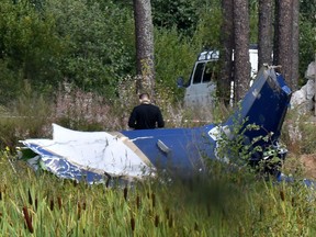 A law enforcement officer works at the site of a plane crash near the village of Kuzhenkino, Tver region, on August 24, 2023.