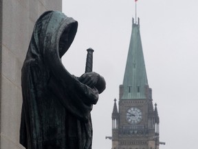 The statue representing justice looks out from the Supreme Court of Canada over the Parliamentary precinct in Ottawa.