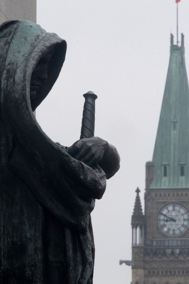The statue representing justice looks out from the Supreme Court of Canada over the Parliamentary precinct in Ottawa.