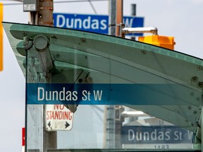 Signs reading Dundas Street West are seen in Toronto.