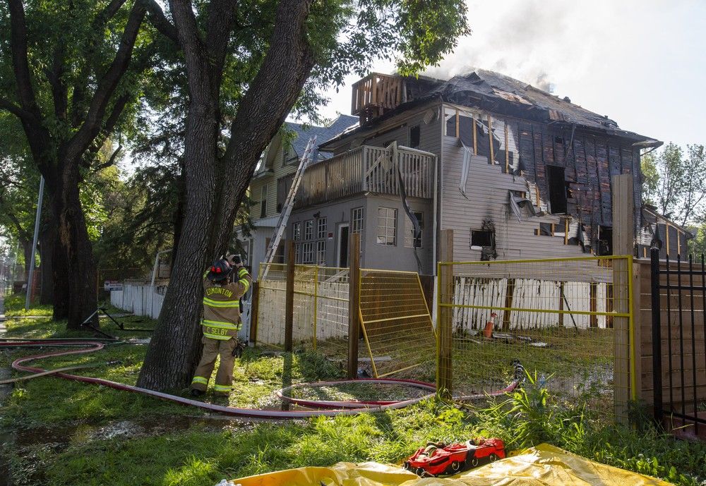 Firefighters work to control the fire in a house at 9529 103 Ave. on Wednesday, Aug. 2, 2023, in Edmonton. Firefighters were called to a house fire in central Edmonton at around 5:35 a.m. The crews had the fire out just before 7 a.m.