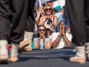 People in the audience react as dancers perform on stage