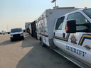 Alberta Sheriffs vehicles, seen on the tarmac at Edmonton International Airport, prepare to receive inmates evacuated from the Northwest Territories due to wildfires. Inmates will be transferred to facilities in Edmonton for the duration of the evacuation period.