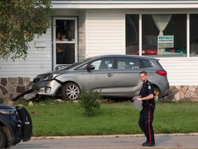 A car plowed into a house at the corner of 75 Street and 98 Ave on Tuesday, Aug. 29, 2023. A large police presence and collision investigations were at the scene of a dayhome.