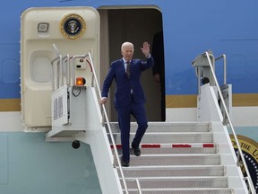 President Joe Biden exits Air Force One after landing at Roland R. Wright Air National Guard Base, Wednesday, Aug. 9, 2023, in Salt Lake City.