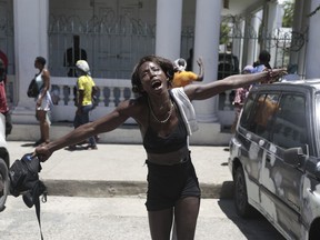 A woman shouts out how her family members died at the hands of gangs members in the Carrefour-Feuilles neighborhood, during a protest against insecurity in Port-au-Prince, Haiti, Friday, Aug. 25, 2023.