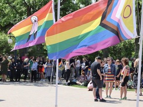 Pride flags wave above a crowd of about 250 people that gathered for the beginning of Pride Month on the University of Saskatchewan campus.