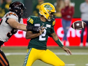 The B.C. Lions' Mathieu Betts (90) knocks the balls out of the hands of Edmonton Elks' quarterback Tre Ford (2) during first half CFL action at Commonwealth Stadium, in Edmonton Friday Sept. 22, 2023. Photo by David Bloom