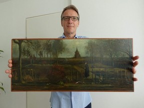 A handout picture released by Dutch art detective Arthur Brand shows a portrait of him posing with the painting title 