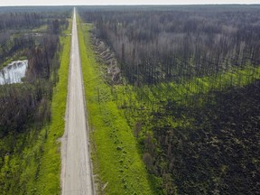 An aerial view of a burned section of the East Prairie Metis Settlement, Alta., Tuesday, July 4, 2023.&ampnbsp;Residents of a First Nations community in northern Alberta who had to evacuate in the spring due to an encroaching wildfire have been forced to flee again due to an out-of-control blaze.