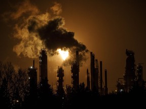 Even if no new government climate policies are introduced before 2030, global demand for fossil fuels will still peak before the end of this decade, a new report by the International Energy Agency states. A flare stack lights the sky from a refinery in Edmonton on December 28, 2018.