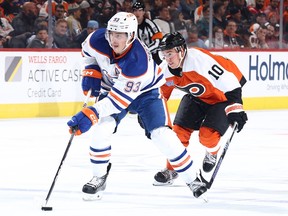 Ryan Nugent-Hopkins #93 of the Edmonton Oilers skates with the puck past Bobby Brink #10
