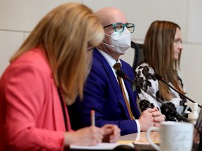 Councillors Jo-Anne Wright, left, Andrew Knack, and Karen Principe take part in the first day of public hearings on potential changes to zoning bylaws in Edmonton on Monday, Oct. 16, 2023.
