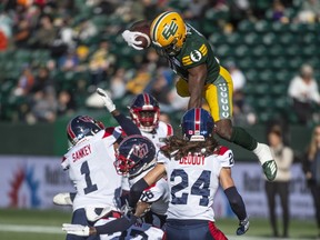Edmonton Elks running back Kevin Brown goes up and over the defence of the Montreal Alouettes at Commonwealth Stadium in Edmonton on Saturday, Oct. 14, 2023.