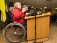 Paralympian Heather Kuttai speaks at a height adjustable podium in Saskatoon.