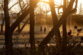 Pedestrians make their way through the University of Alberta Farm at dusk, in Edmonton Monday Nov. 20, 2023. Photo by David Bloom