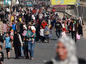Palestinians walk down a road as they flee Gaza City and other parts of northern Gaza towards the southern areas on Nov. 8.