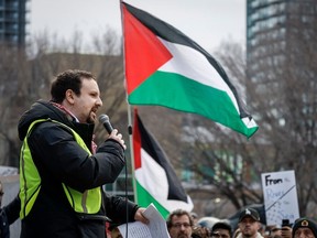 Wesam Cooley, who also goes by Wesam Khaled, addresses a pro-Palestinian rally in Calgary on Sunday, Nov. 19, 2023. The Crown dropped criminal charges laid against him for saying a contentious phrase at an earlier demonstration.