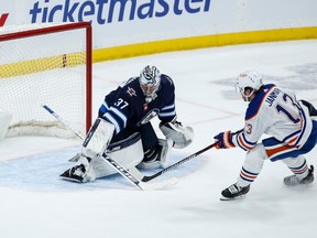 Winnipeg Jets goaltender Connor Hellebuyck (37) saves the breakaway shot from Edmonton Oilers' Mattias Janmark