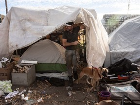 A human rights group is expressing concern that its court application to pause the City of Edmonton's dismantling of homeless encampments won't be heard until the new year, well after winter weather has settled in. Joshua Bell is pictured at his tent in Edmonton on Thursday, Oct. 19, 2023.