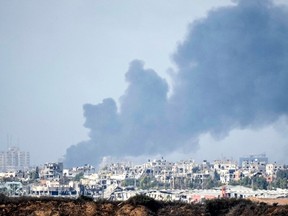 In this photograph taken near the Israeli border with the Gaza Strip a large ploom of smoke rises over Gaza City on November 14, 2023 near Sderot, Israel.