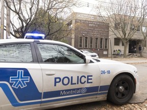 A police vehicle sits outside Yeshiva Gedola of Montreal, a Jewish school that was hit by gunshots for the second time in three days, Monday, Nov. 13, 2023.
