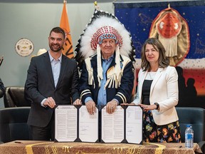 Dan Williams, Alberta minister of mental health and addiction, left, Tsuut’ina Nation Chief Roy Whitney, and Alberta Premier Danielle Smith sign a memorandums of understanding with Tsuut’ina Nation to increase addiction treatment capacity on First Nations lands at Chief Joseph Big Plume Building on Wednesday, July 5, 2023.