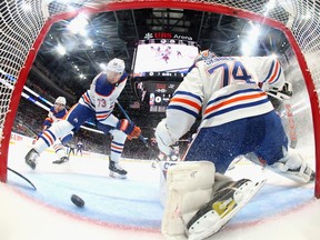 Vincent Desharnais #73 and Stuart Skinner #74 of the Edmonton Oilers defend the net against the New York Islanders at UBS Arena on Tuesday, Dec. 19, 2023 in Elmont, New York.