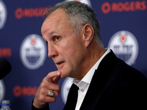 Paul Coffey with an Oilers logo wall in the background