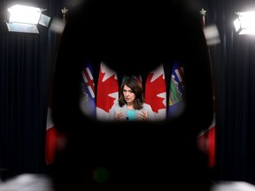 Premier Danielle Smith is framed by a camera during a news conference at the Alberta legislature in this photo from Nov. 28, 2023.