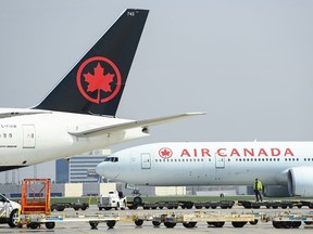 Air Canada planes sit on the tarmac at Pearson International Airport in Toronto on Wednesday, April 28, 2021.