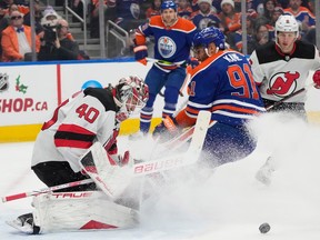 Edmonton Oilers Evander Kane (91) can't get the puck past New Jersey Devils goalie Akira Schmid (40) during first period NHL action on Sunday, Dec. 10, 2023 in Edmonton.   Greg Southam-Postmedia