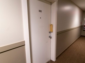 An apartment door is shown in a hallway.