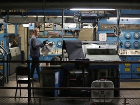 A press operator looks over the registration and color of a newspaper in Youngstown, Ohio on Aug.7, 2019. There was a flurry of closures of local Canadian newsrooms in 2023 that left municipal governments, non-profits and journalists themselves trying to figure out what's next.THE CANADIAN PRESS/AP-Tony Dejak