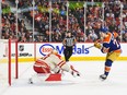 Oilers forward Ruyan McLeod scores on Flames goaltender Dan Vladar