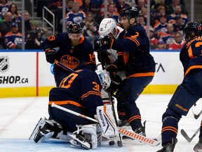 Oilers goalie Calvin Pickard stops a scoring chance with a crowd of OIlers players around the net