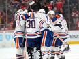 Oilwers players celebrate their win in the middle of the ice.