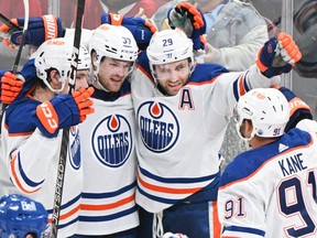 Edmonton Oilers' Leon Draisaitl (29) celebrates with teammates after scoring against the Montreal Canadiens during third period NHL hockey action in Montreal on Saturday, Jan. 13, 2024.