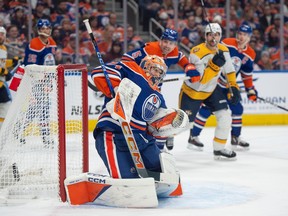Stuart Skinner (74) of the Edmonton Oilers, deflects a shot into the netting against the Nashville Predators at Rogers Place in Edmonton on Jan.27, 2024. Photo by Shaughn Butts-Postmedia