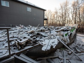 The remnants of a newly built home that was burned down and is under investigation of arson in Edmonton on Friday, Jan. 5, 2024. Police in at least three provinces are now dealing with investigations of extortion schemes with the common thread of targeting business owners in the South Asian community.