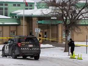 A vehicle is removed by tow truck at John Costello Catholic School, which was cordoned off by Calgary police as officers investigated a domestic homicide outside the school on Tuesday, January 16, 2024.