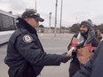 A screen grab from the video shows a Toronto police officer and a protestor who then refers to the police as "our little messengers."