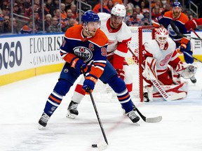 The Edmonton Oilers' Connor McDavid (97) battles the Detroit Red Wings' Andrew Copp (18) during first period NHL action at Rogers Place, in Edmonton Tuesday Feb. 13, 2024. Photo by David Bloom
