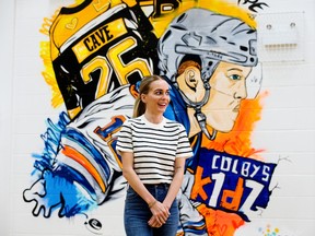 Emily Cave stands with a new mural on Tuesday. Feb. 20, 2024, at the CASA Centre, 10645 63 Ave., that pays tribute to her late husband Colby Cave, former Oilers forward and mental health champion.