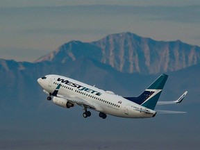A WestJet Boeing 737 climbs after take-off from the Calgary International Airport on Oct. 5, 2021.