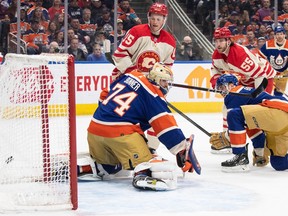 Calgary Flames' Noah Hanifin (55) scores a goal on Edmonton Oilers goalie Stuart Skinner (74) during first period NHL action in Edmonton on Saturday Feb. 24, 2024.